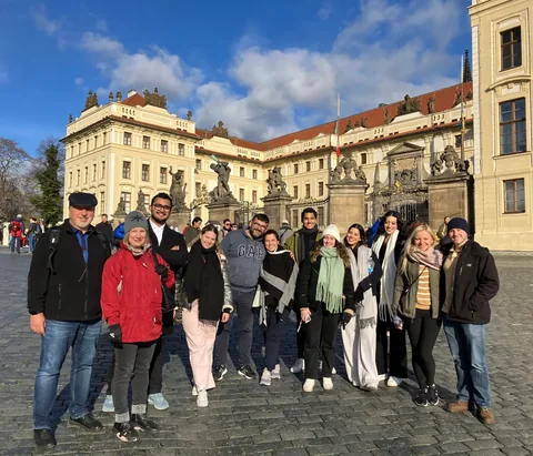 Tour guests gathered on the cobblestones beside the Prague Castle entrance.