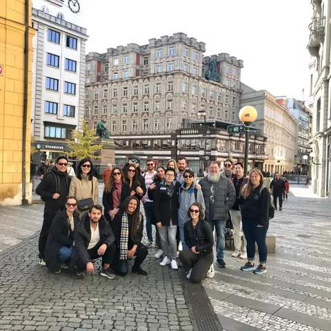 Travellers posing together on a cobbled New Town street lined with historic buildings.